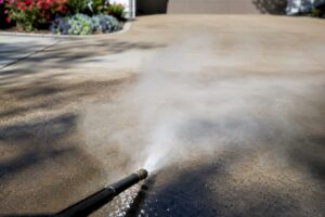 Hot water pressure washing wand spraying steam